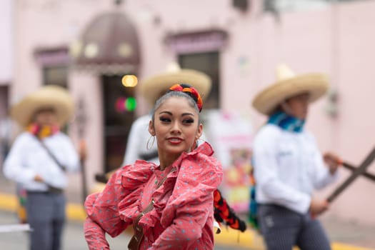 Matamoros, Tamaulipas, Mexico - November 20, 2018: The November 20 Parade, Young women and men dancing wearing traditional mexican clothing during the parade