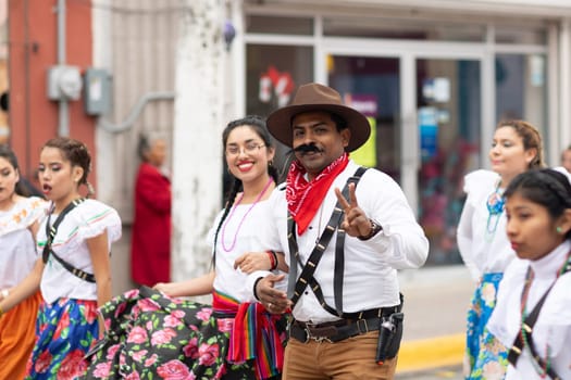 Matamoros, Tamaulipas, Mexico - November 20, 2018: The November 20 Parade, Man and woman wearing traditional mexican clothing going down the road during the parade