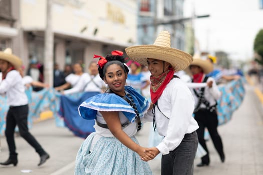 Matamoros, Tamaulipas, Mexico - November 20, 2018: The November 20 Parade, Young women and men dancing wearing traditional mexican clothing during the parade