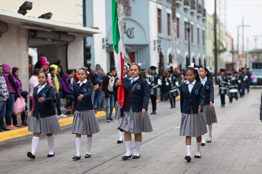 Matamoros, Tamaulipas, Mexico - November 20, 2018: The November 20 Parade, The Mexican Flag being scorted by students at the parade