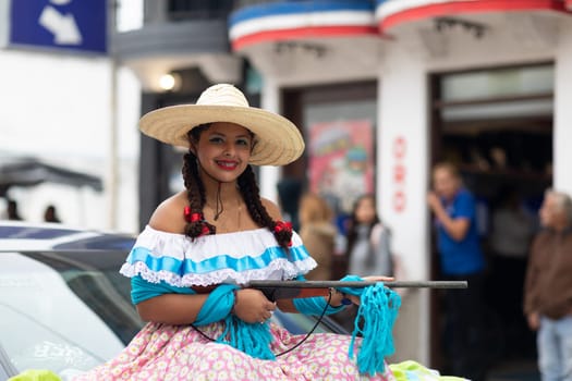 Matamoros, Tamaulipas, Mexico - November 20, 2018: The November 20 Parade, Young Girl wearing traditional clothing Holding a toy rifle at the parade