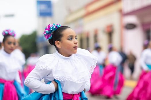 Matamoros, Tamaulipas, Mexico - November 20, 2018: The November 20 Parade, Young women wearing traditional Mexican clothing dancing