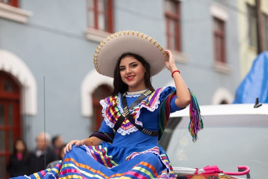 Matamoros, Tamaulipas, Mexico - November 20, 2018: The November 20 Parade, Young Mexican woman wearing traditional mexican clothing going down the road during the parade