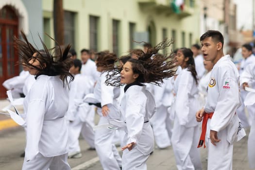 Matamoros, Tamaulipas, Mexico - November 20, 2018: The November 20 Parade, Young men and women practicing martial arts during the parade