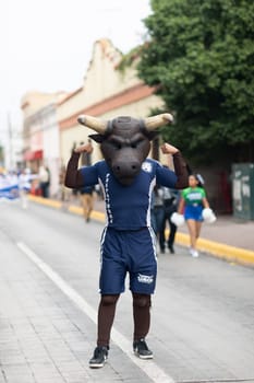 Matamoros, Tamaulipas, Mexico - November 20, 2018: The November 20 Parade, Man dress up as a toro, mascot of the prepa Juan Jose De La Garza