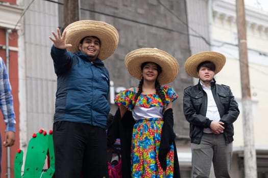 Matamoros, Tamaulipas, Mexico - November 20, 2018: The November 20 Parade, Woman and men with sombreros and traditional mexican clothing going down the road on a float