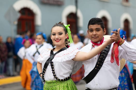 Matamoros, Tamaulipas, Mexico - November 20, 2018: The November 20 Parade, Young women and men dancing wearing traditional mexican clothing during the parade
