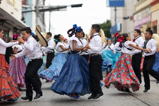 Matamoros, Tamaulipas, Mexico - November 20, 2018: The November 20 Parade, Young women and men dancing wearing traditional mexican clothing during the parade