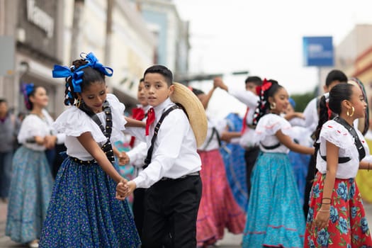 Matamoros, Tamaulipas, Mexico - November 20, 2018: The November 20 Parade, Young women and men dancing wearing traditional mexican clothing during the parade