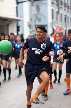 Matamoros, Tamaulipas, Mexico - November 20, 2018: The November 20 Parade, Young men playing Soccer with a green ball during the parade