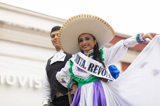Matamoros, Tamaulipas, Mexico - November 20, 2018: The November 20 Parade, Young woman and man wearing traditional clothing with a sombrero on top of a float