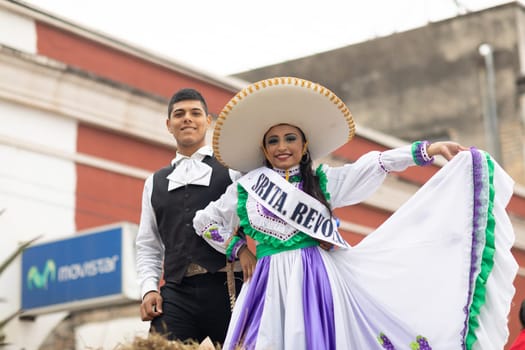 Matamoros, Tamaulipas, Mexico - November 20, 2018: The November 20 Parade, Young woman and man wearing traditional clothing with a sombrero on top of a float