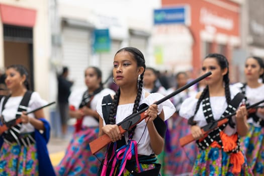 Matamoros, Tamaulipas, Mexico - November 20, 2018: The November 20 Parade, Young Girl wearing traditional clothing Holding a toy rifle at the parade