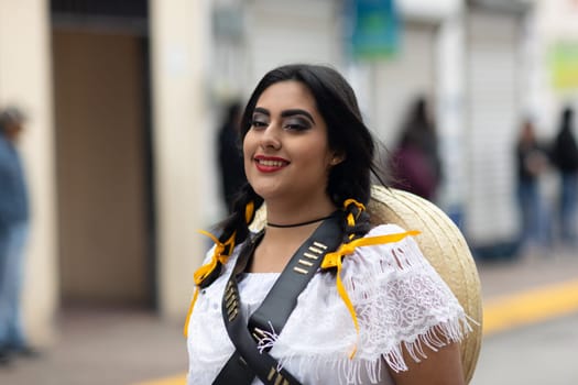 Matamoros, Tamaulipas, Mexico - November 20, 2018: The November 20 Parade, Young Mexican woman wearing traditional mexican clothing going down the road during the parade