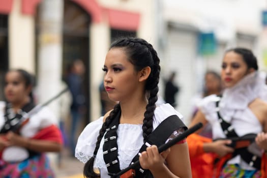Matamoros, Tamaulipas, Mexico - November 20, 2018: The November 20 Parade, Young Girl wearing traditional clothing Holding a toy rifle at the parade