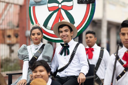 Matamoros, Tamaulipas, Mexico - November 20, 2018: The November 20 Parade, Young man and woman wearing traditional clothing going down the road on a float
