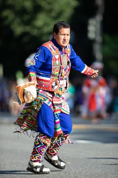 Washington, D.C., USA - September 29, 2018: The Fiesta DC Parade, Bolivian men wearing traditional clothing performing a traditional Bolivian dance