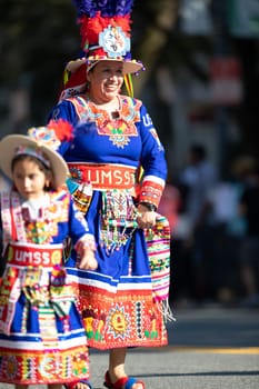 Washington, D.C., USA - September 29, 2018: The Fiesta DC Parade, woman and girl from bolivia wearing traditional clothing dancing