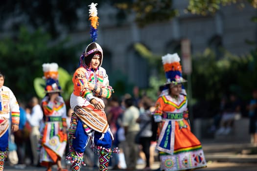 Washington, D.C., USA - September 29, 2018: The Fiesta DC Parade, children from bolivia wearing traditional clothing dancing