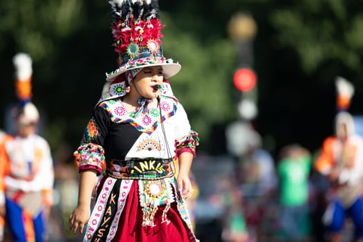 Washington, D.C., USA - September 29, 2018: The Fiesta DC Parade, Bolivian women wearing traditional clothing performing a traditional dance from bolivia