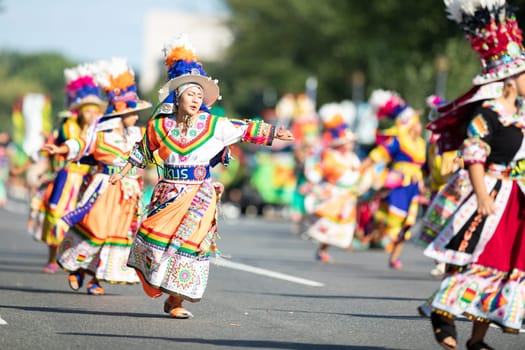 Washington, D.C., USA - September 29, 2018: The Fiesta DC Parade, Bolivian women wearing traditional clothing performing a traditional dance from bolivia
