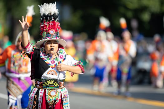 Washington, D.C., USA - September 29, 2018: The Fiesta DC Parade, Bolivian women wearing traditional clothing performing a traditional dance from bolivia