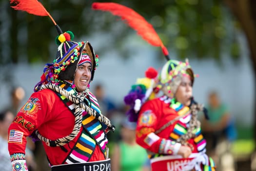 Washington, D.C., USA - September 29, 2018: The Fiesta DC Parade, Bolivian men wearing traditional clothing performing a traditional Bolivian dance