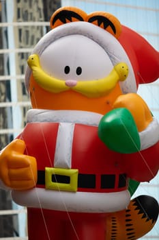 Houston, Texas, USA - November 22, 2018 The H-E-B Thanksgiving Day Parade, A balloon in shape of Garfield, dress up as Santa Claus