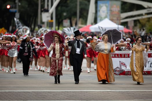 Houston, Texas, USA - November 22, 2018 The H-E-B Thanksgiving Day Parade, Men and women wearing traditional clothing waving to the spectators