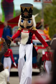 Houston, Texas, USA - November 22, 2018 The H-E-B Thanksgiving Day Parade,  African American dress up as a Nutcracker, walks on stilts, giving a high five
