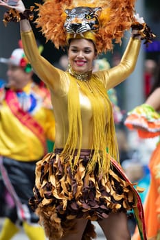Houston, Texas, USA - November 22, 2018 The H-E-B Thanksgiving Day Parade, Colombian woman wearing carnival clothing dancing during the parade