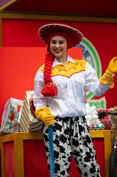 Houston, Texas, USA - November 22, 2018 The H-E-B Thanksgiving Day Parade, Woman on a float waving at people dress up as Jessie Toy Story Character