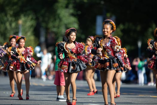Washington, D.C., USA - September 29, 2018: The Fiesta DC Parade, Bolivian women wearing traditional clothing performing a traditional dance from bolivia