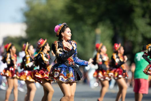 Washington, D.C., USA - September 29, 2018: The Fiesta DC Parade, Bolivian women wearing traditional clothing performing a traditional dance from bolivia