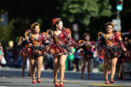 Washington, D.C., USA - September 29, 2018: The Fiesta DC Parade, Bolivian women wearing traditional clothing performing a traditional dance from bolivia