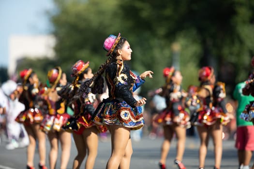 Washington, D.C., USA - September 29, 2018: The Fiesta DC Parade, Bolivian women wearing traditional clothing performing a traditional dance from bolivia
