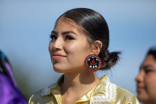 Milwaukee, Wisconsin, USA - September 8, 2018 The Indian Summer Festival Young woman wearing traditional native american clothing at the pow wow competition.