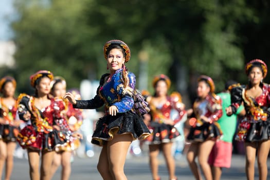 Washington, D.C., USA - September 29, 2018: The Fiesta DC Parade, Bolivian women wearing traditional clothing performing a traditional dance from bolivia