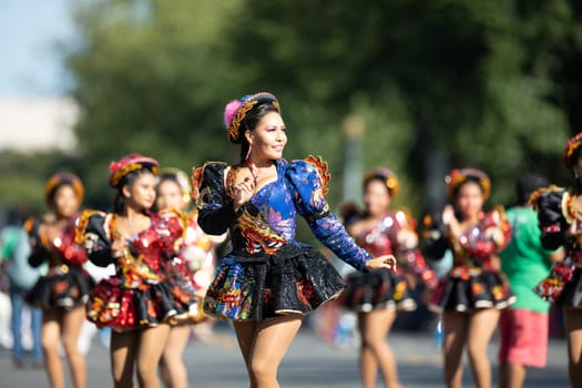 Washington, D.C., USA - September 29, 2018: The Fiesta DC Parade, Bolivian women wearing traditional clothing performing a traditional dance from bolivia