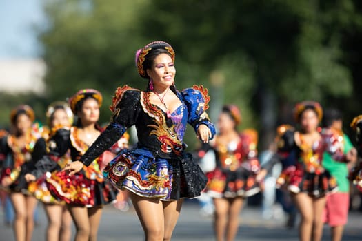 Washington, D.C., USA - September 29, 2018: The Fiesta DC Parade, Bolivian women wearing traditional clothing performing a traditional dance from bolivia