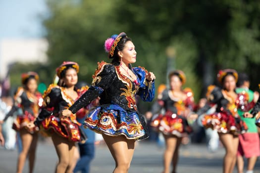 Washington, D.C., USA - September 29, 2018: The Fiesta DC Parade, Bolivian women wearing traditional clothing performing a traditional dance from bolivia