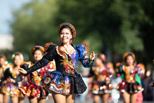 Washington, D.C., USA - September 29, 2018: The Fiesta DC Parade, Bolivian women wearing traditional clothing performing a traditional dance from bolivia