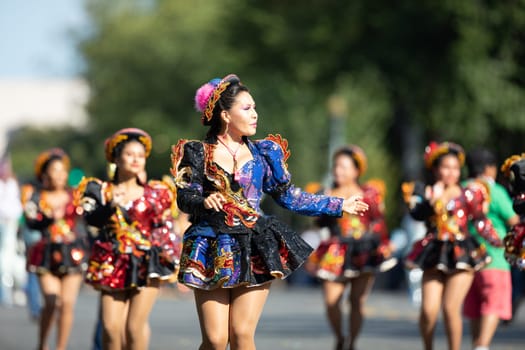 Washington, D.C., USA - September 29, 2018: The Fiesta DC Parade, Bolivian women wearing traditional clothing performing a traditional dance from bolivia