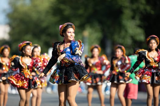 Washington, D.C., USA - September 29, 2018: The Fiesta DC Parade, Bolivian women wearing traditional clothing performing a traditional dance from bolivia