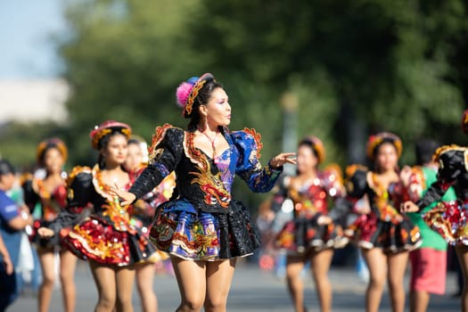 Washington, D.C., USA - September 29, 2018: The Fiesta DC Parade, Bolivian women wearing traditional clothing performing a traditional dance from bolivia