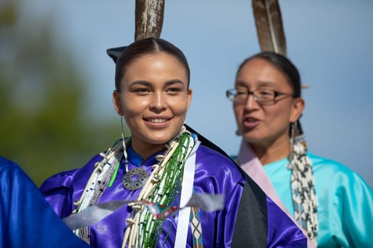 Milwaukee, Wisconsin, USA - September 8, 2018 The Indian Summer Festival, Young woman wearing traditional native american clothing, dancing at the pow wow competition.