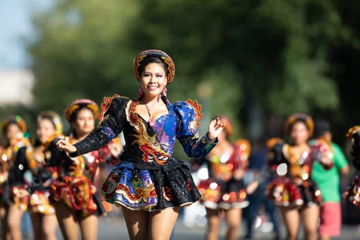 Washington, D.C., USA - September 29, 2018: The Fiesta DC Parade, Bolivian women wearing traditional clothing performing a traditional dance from bolivia