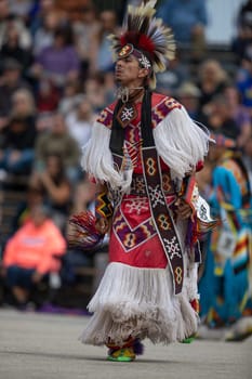 Milwaukee, Wisconsin, USA - September 8, 2018 The Indian Summer Festival, Man wearing traditional native american clothing, dancing at the pow wow competition.