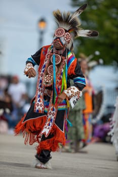 Milwaukee, Wisconsin, USA - September 8, 2018 The Indian Summer Festival, Man wearing traditional native american clothing, dancing at the pow wow competition.