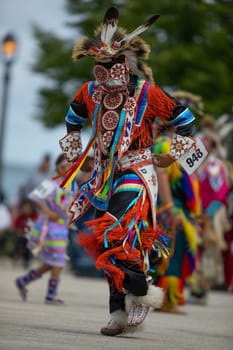 Milwaukee, Wisconsin, USA - September 8, 2018 The Indian Summer Festival, Man wearing traditional native american clothing, dancing at the pow wow competition.